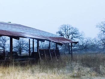 House on field against clear sky