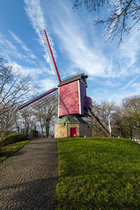 Low angle view of built structure on field against sky