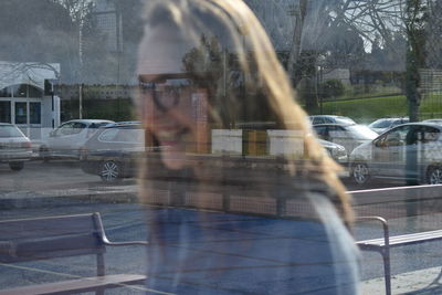 Portrait of man seen through car windshield