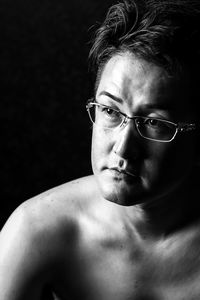 Close-up of young man over black background