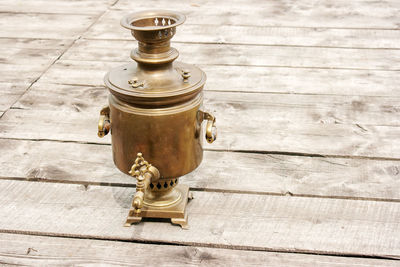 Close-up of old coffee grinder on table