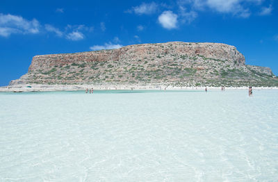 Scenic view of beach against blue sky