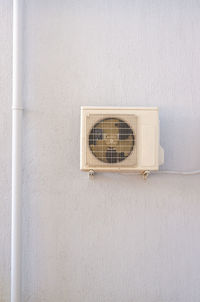 Electric fan on white wall