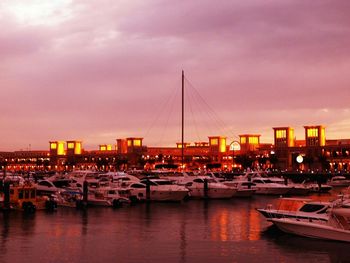 Boats in river with city in background