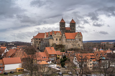 Buildings in town against sky