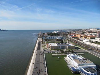 High angle view of sea by buildings against sky