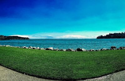 Scenic view of sea against blue sky