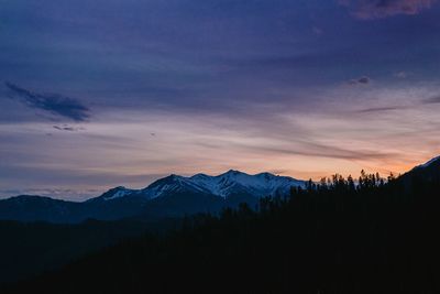 Scenic view of silhouette mountains against sky during sunset