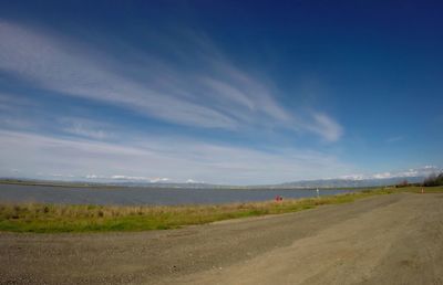 Road by landscape against sky