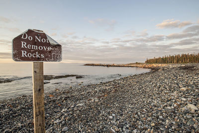 Sign on beach warning tourists not to remove rocks in acadia, maine