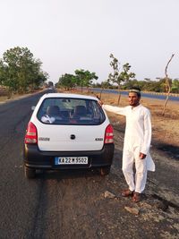 Man standing on road against sky