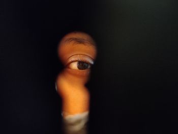 Close-up of human hand against black background