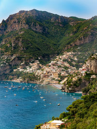 Scenic view of sea and mountains against sky