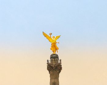 Low angle view of statue against sky