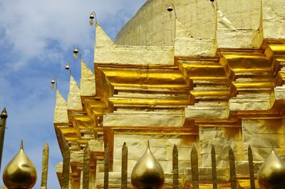 Low angle view of sculptures on building against sky