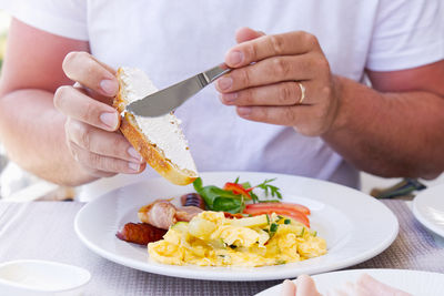 Midsection of man holding food