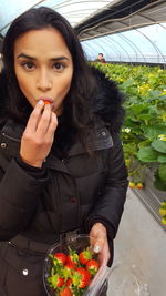 Portrait of young woman holding ice cream