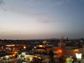 High angle view of city lit up at night