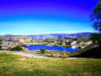 Scenic view of lake against clear blue sky
