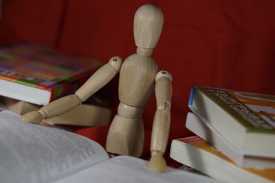 Wooden figurine with open book