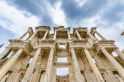 Low angle view of historical building against cloudy sky