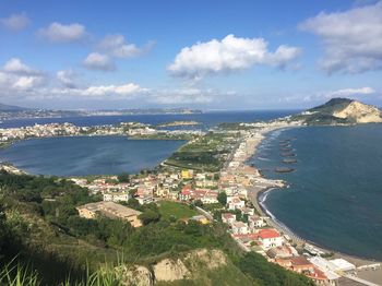 High angle view of townscape by sea against sky