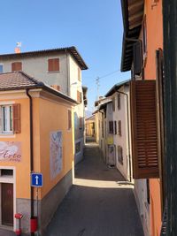 Street amidst buildings in town against clear sky