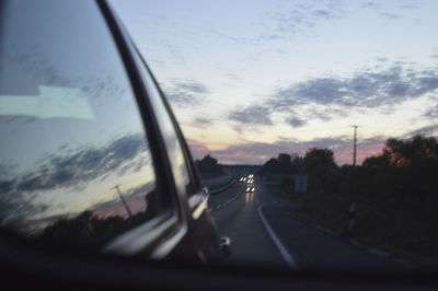 Car on illuminated window at dusk