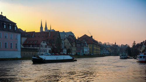 Boats in river with buildings in background