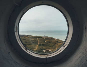 Scenic view of sea against sky seen through window