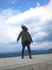 Full length of man standing on land against sky