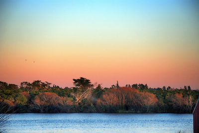 Scenic view of calm sea at sunset