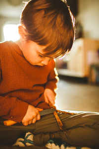 Midsection of boy working with knife