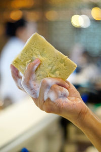 Close-up of hand holding ice cream