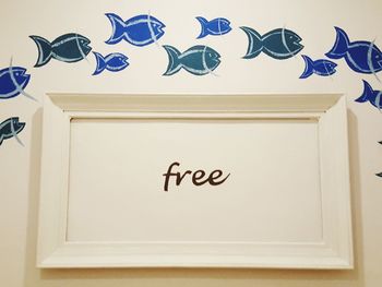 Close-up of text on white wall