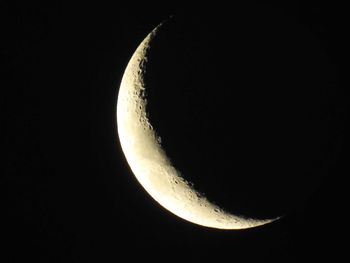 Low angle view of moon against clear sky at night