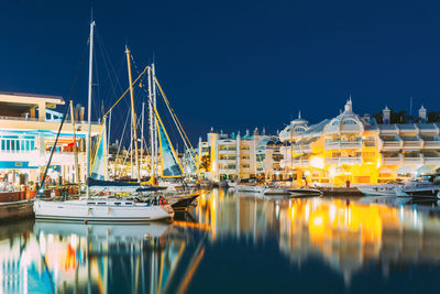 Boats moored at harbor