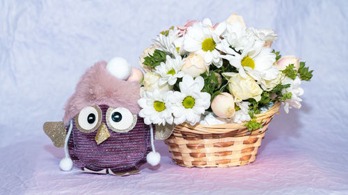 Close-up of white flowers in basket on table