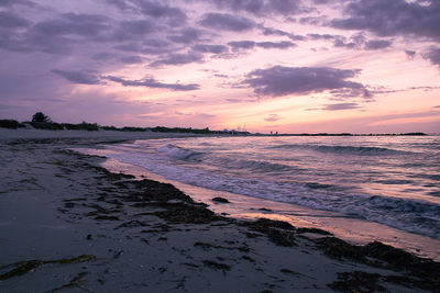 Scenic view of beach against sky during sunset