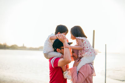 Side view of family against sky