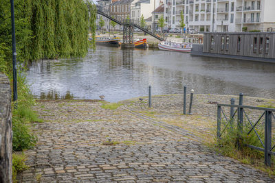 Footpath by river in city