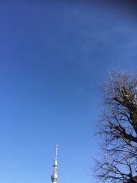 Low angle view of tower against blue sky