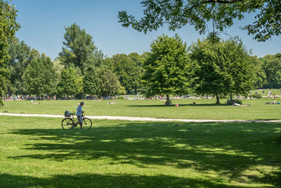 Woman walking with bicycle in park