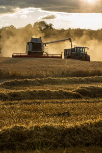 View of rural landscape against cloudy sky