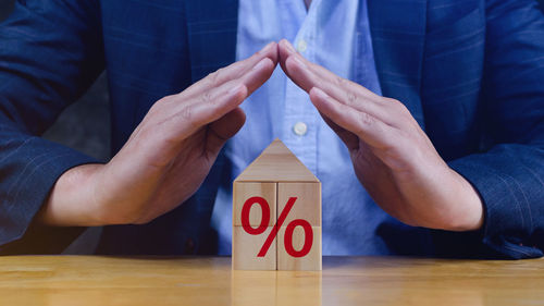 Midsection of businessman playing block on table