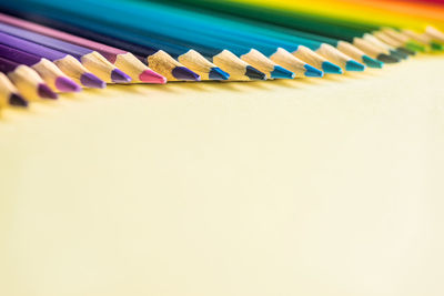 Close-up of multi colored pencils on table