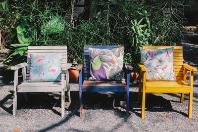 Empty chairs and table in yard