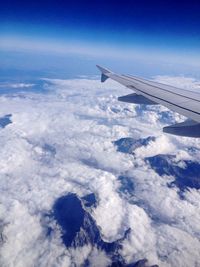 Cropped image of airplane wing over landscape