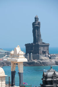 Statue of temple against clear blue sky