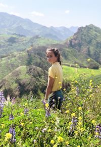 Full length of woman standing on mountain